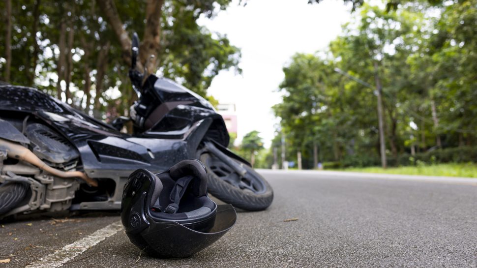 Motorcycle accident with helmet on road and safety reminder Save Life message, concept of road safety and awareness