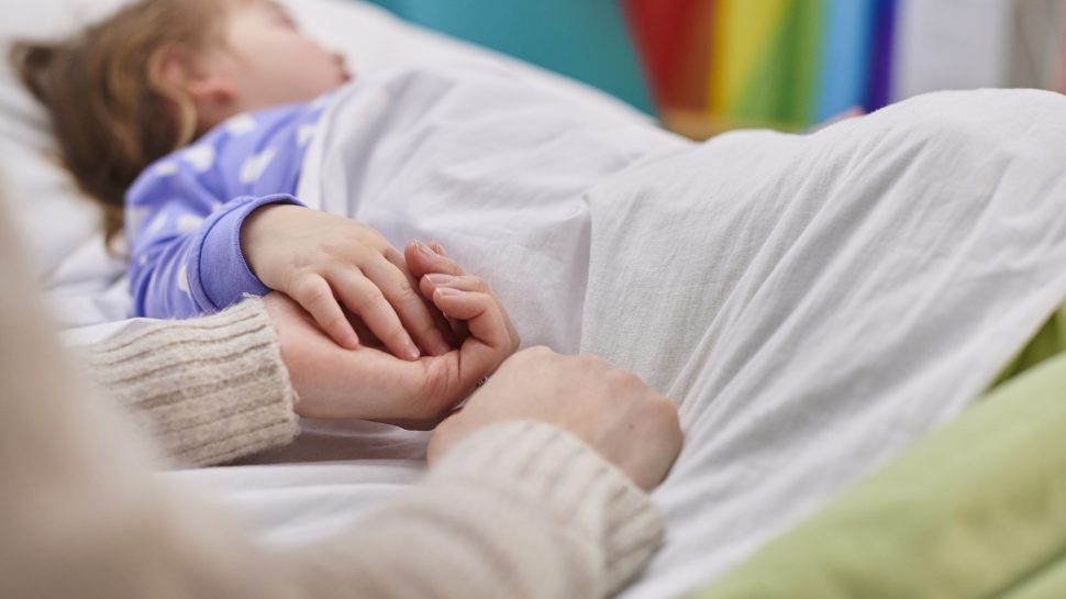 Child laying in hospital bed after negligence from daycare accident