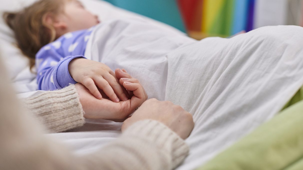 Child laying in hospital bed after negligence from daycare accident